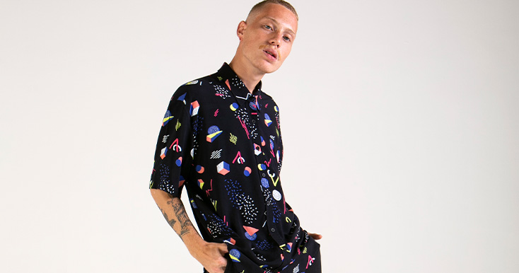 Modelo com camisa estampada colorida e moderna.