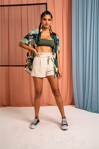 Modelo feminina com roupas de verão em fundo colorido